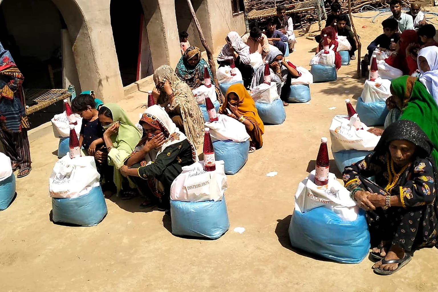 Families receiving relief packages outdoors